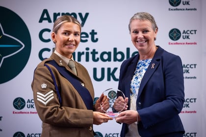 Sally Orange presents an award to an adult volunteer