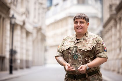 Adult volunteer holds their ACCT UK Award