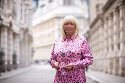 Lady with a pink dress and blonde hair holds her ACCT UK Award
