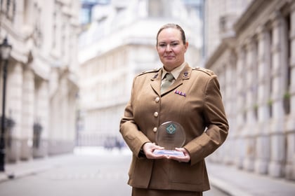 Senior adult volunteer holds ACCT UK award