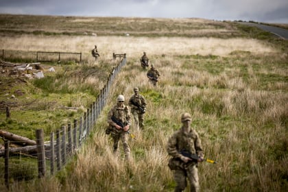 Cadets walk through a field during fieldcraft exercise at Cadet Cambrian Patrol 2026