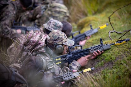 Cadets lie on the ground with weapons drawn during fieldcraft exercise at Cadet Cambrian Patrol 2026