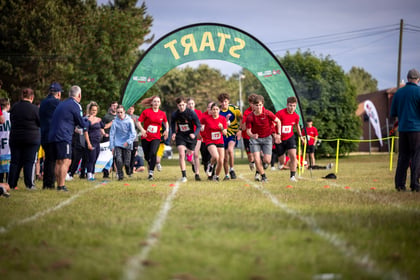 Cadets running with the start banner in the background