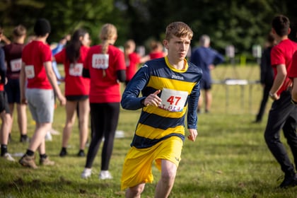 Male cadet running wears navy and yellow running kit