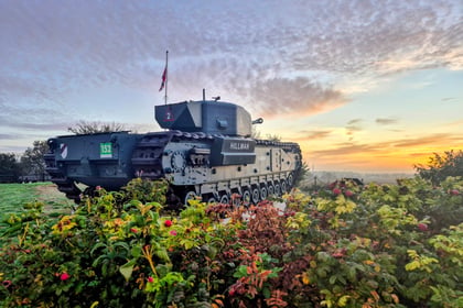 A Churchill tank named Hillman parked in a field at sunrise, reminiscent of a Normandy Battlefield Tour 2026.