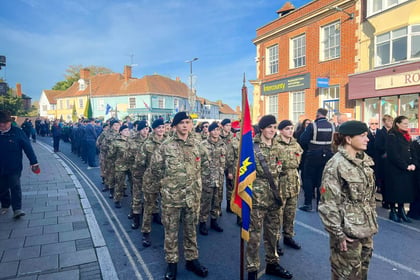 Cadets standing at ease on parade in the road waiting.