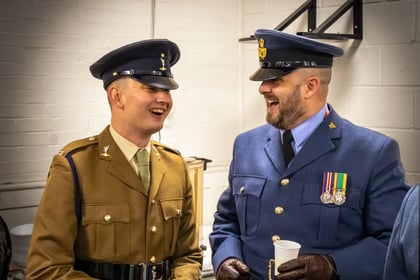 2 Warrant Officers from ACF and RAFAC laugh together whilst wearing formal uniform.