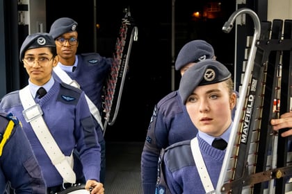 Air cadets walking with their instruments