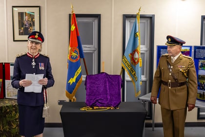 Lord Lieutenant stands in uniform giving a speech. An Army Cadet Lieutenant Colonel to her left.