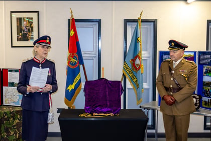 Lord Lieutenant stands in uniform giving a speech. An Army Cadet Lieutenant Colonel to her left.