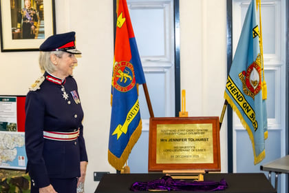 Lord Lieutenant smiling in front of her plaque