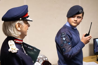 Lord Lieutenant watches an Air Cadet use a radio.