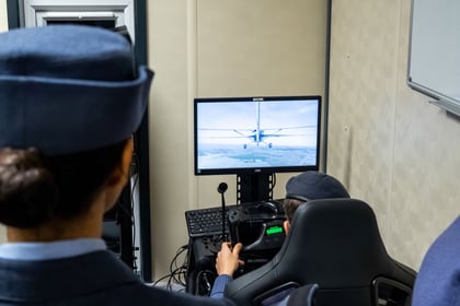 RAFAC demonstrates the use of a flight simulator.