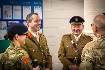 Commandant and Deputy Commandant of Essex Army Cadets smiling whilst talking with other Army Cadet adults.