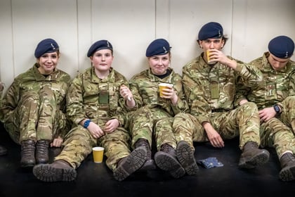 5 Army Cadets sitting in uniform having a break with cups of tea.