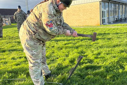 Female cadet hammers in mast