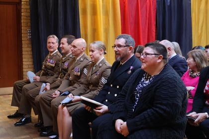 The adult volunteers sat waiting to receive their awards