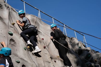 two cadets smiling from the top of the climbing wall