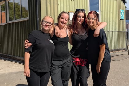 Four female cadets posing for the camera standing together