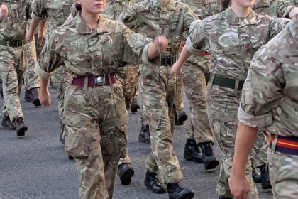 Cadets marching in uniform past the camera