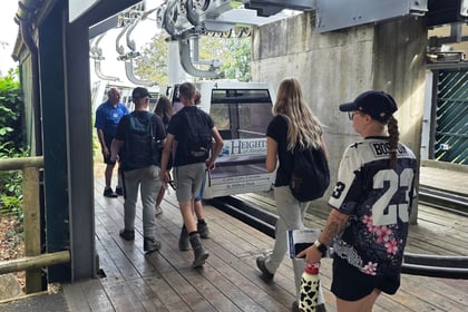 Cadets in civilian clothing are walking towards a cable car about to board it