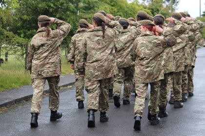 Cadets martching and giving a salute to the left