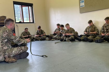 Cadets receiving a Skill at Arms lesson on the cadet GP rifle
