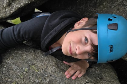 A cadet smiling after rock climbing