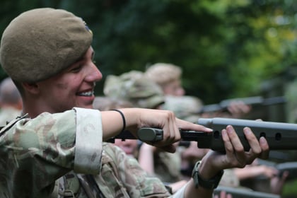 Cadet smiling while conducting NSPs on the rifle