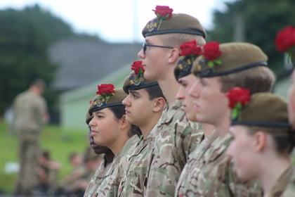 Cadets on parade with red roses in their berets
