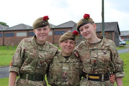 Three cadets smiling at the camera