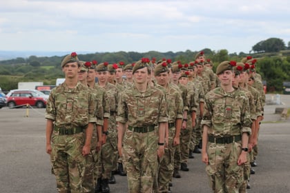 Cadets on parade with red roses in their berets