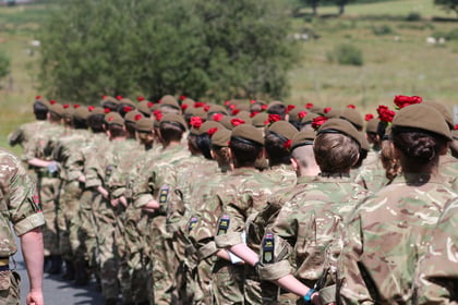 Cadets martching away all with red roses on their beret