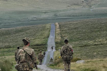 Cadets patroling down a long road