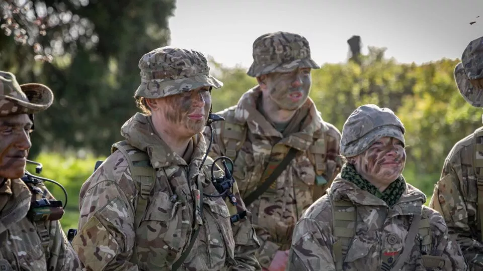 group of senior cadets in camouflage with camps on