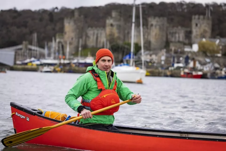 Adult volunteer in red canoe