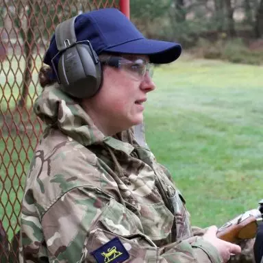 Adult volunteer with ear defence on at shooting activity
