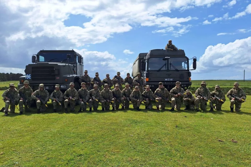 Cadets in front of army wagons