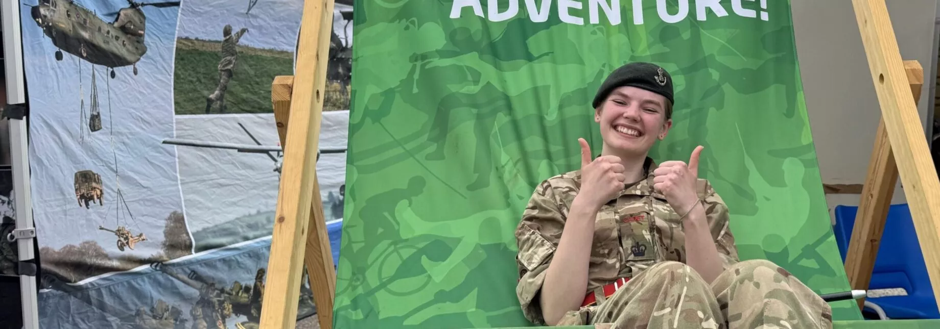 cadet in deck chair, thumbs up.